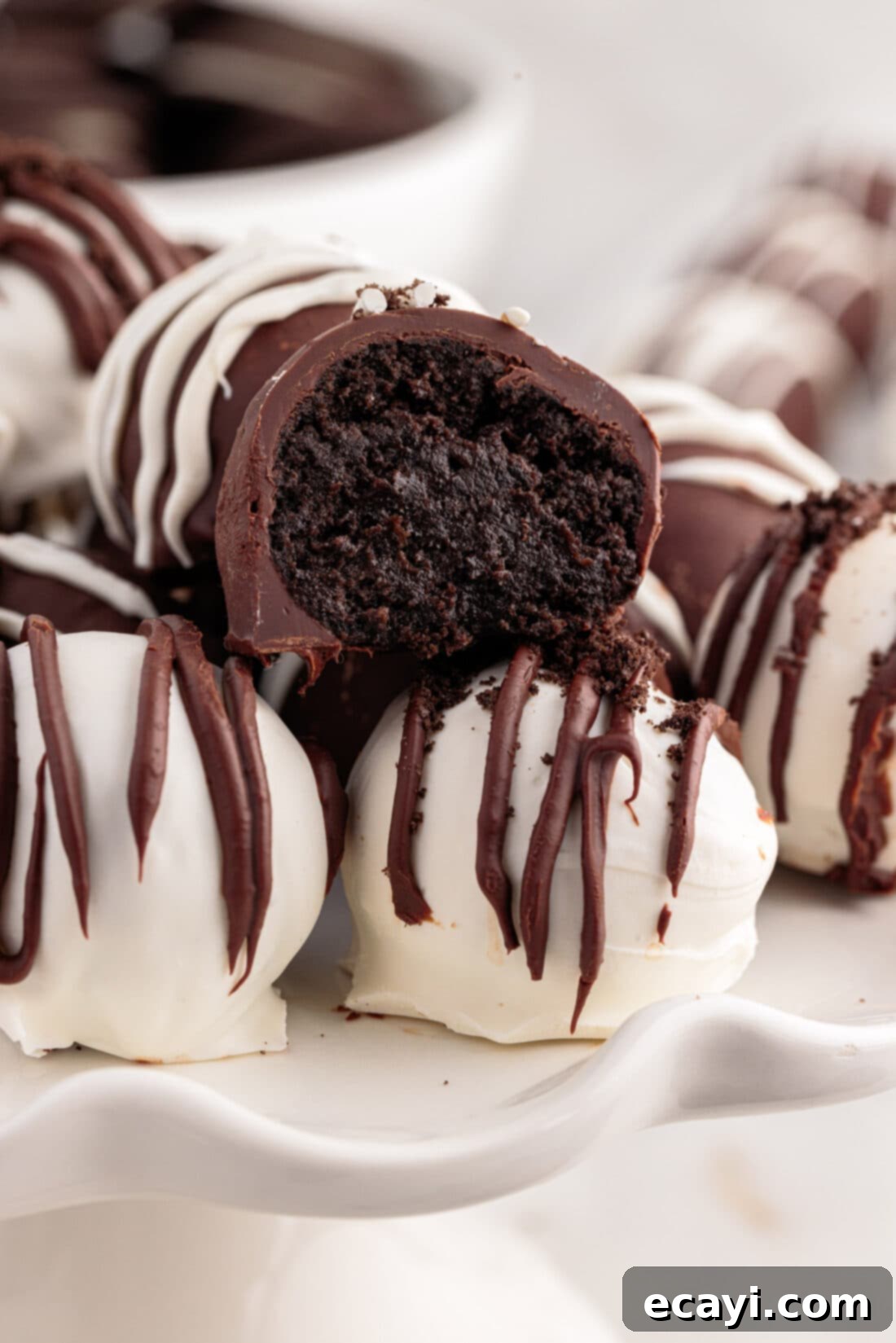Decadent Oreo Truffles 2 Close up photo of an Oreo Truffle with a bite out of it, showing the creamy interior
