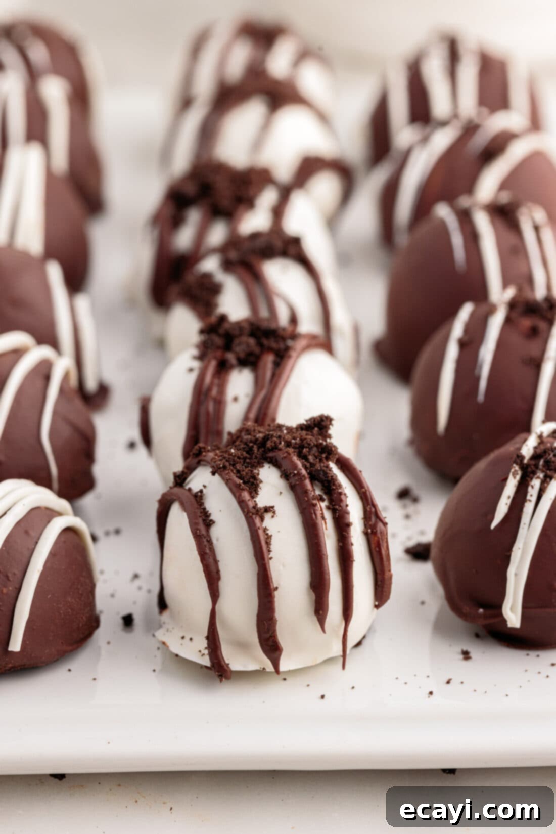 Decadent Oreo Truffles 3 Oreo Truffles lined on on a tray with parchment paper, ready for chilling