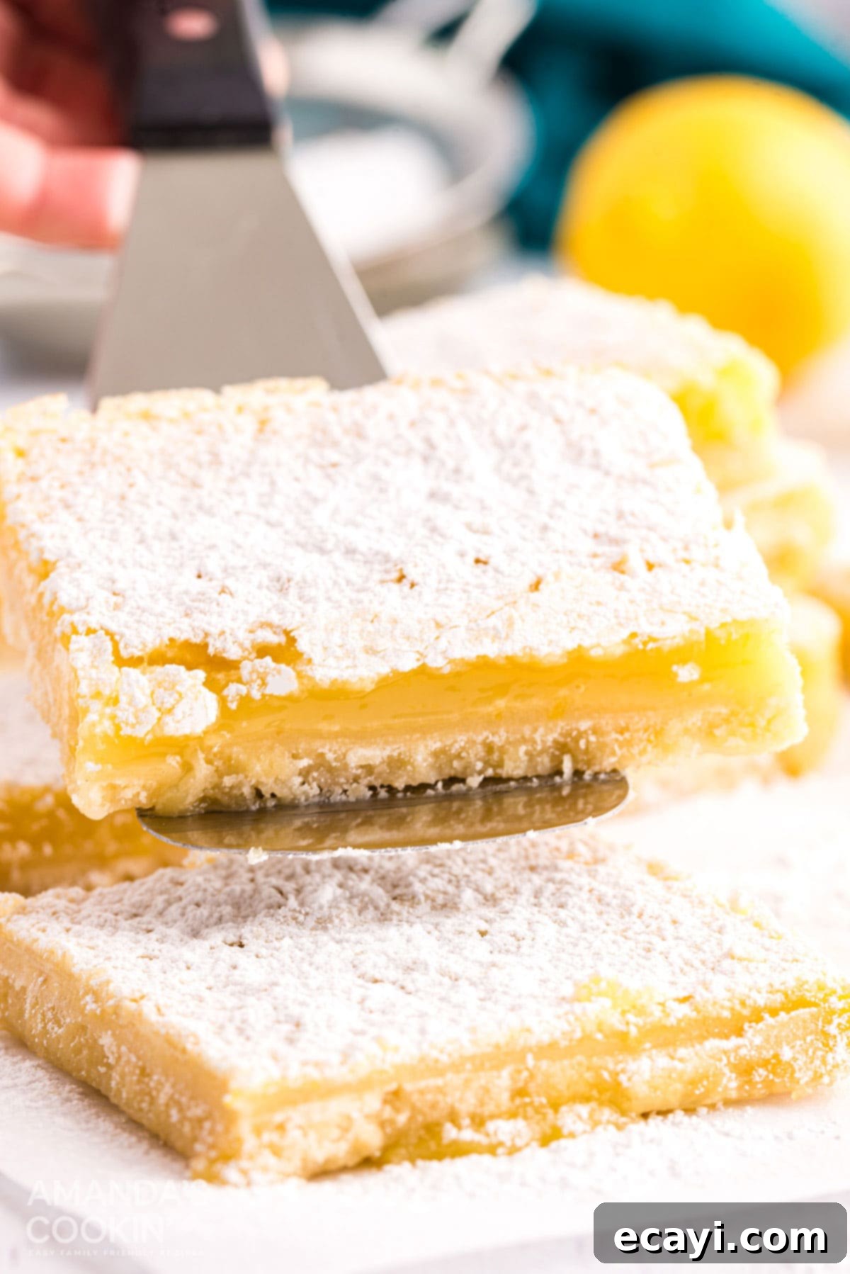 Six ingredients are all that's needed to make these delicious lemon bars. Perfect for any time of year and great for taking to parties. lemon bar being lifted with spatula