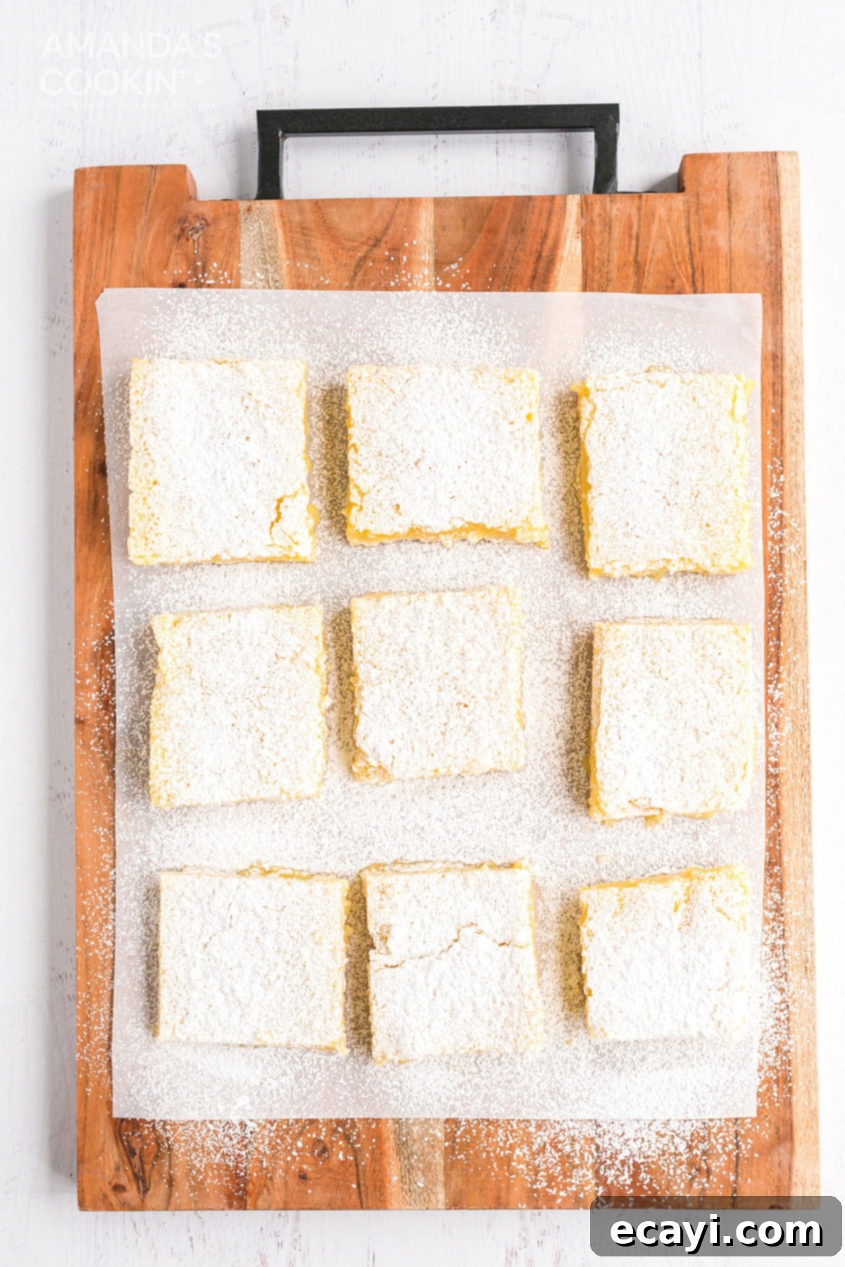 Six ingredients are all that's needed to make these delicious lemon bars. Perfect for any time of year and great for taking to parties. overhead view of lemon bars on a cutting board