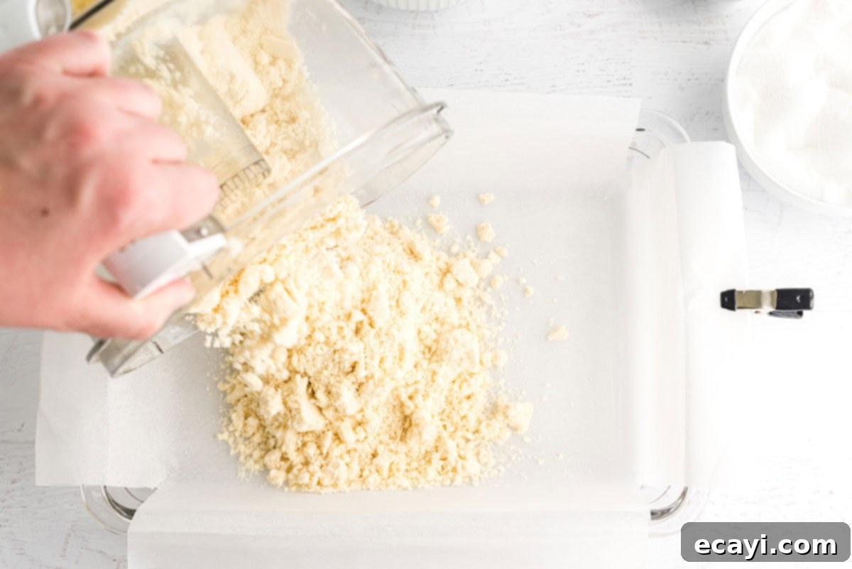 Zesty Lemon Bars 4 pouring shortbread mixture into pan