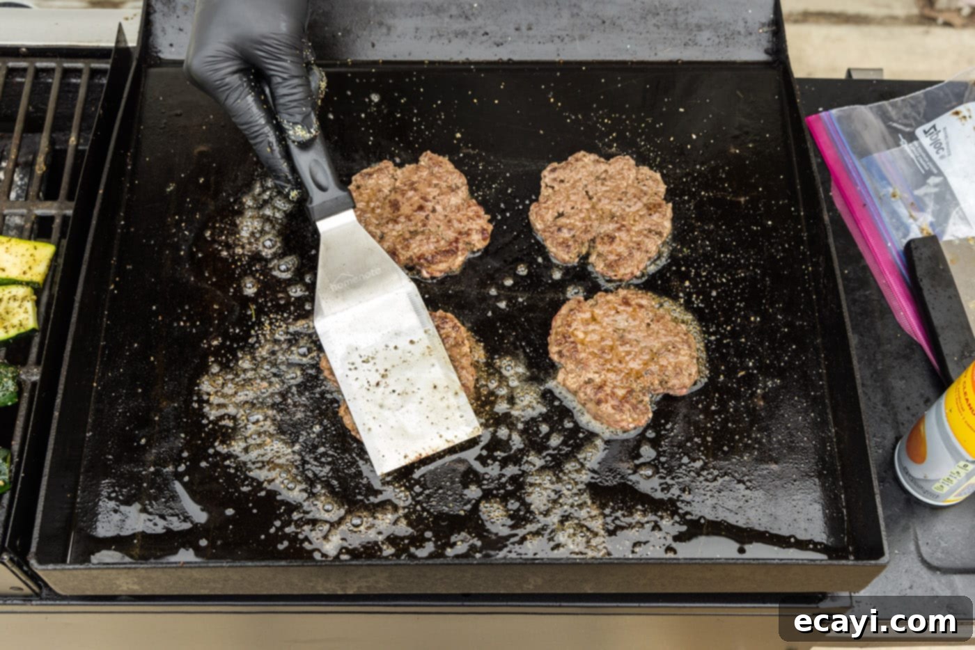 The Smash Burger 11 spatula flattening burger patties on a griddle