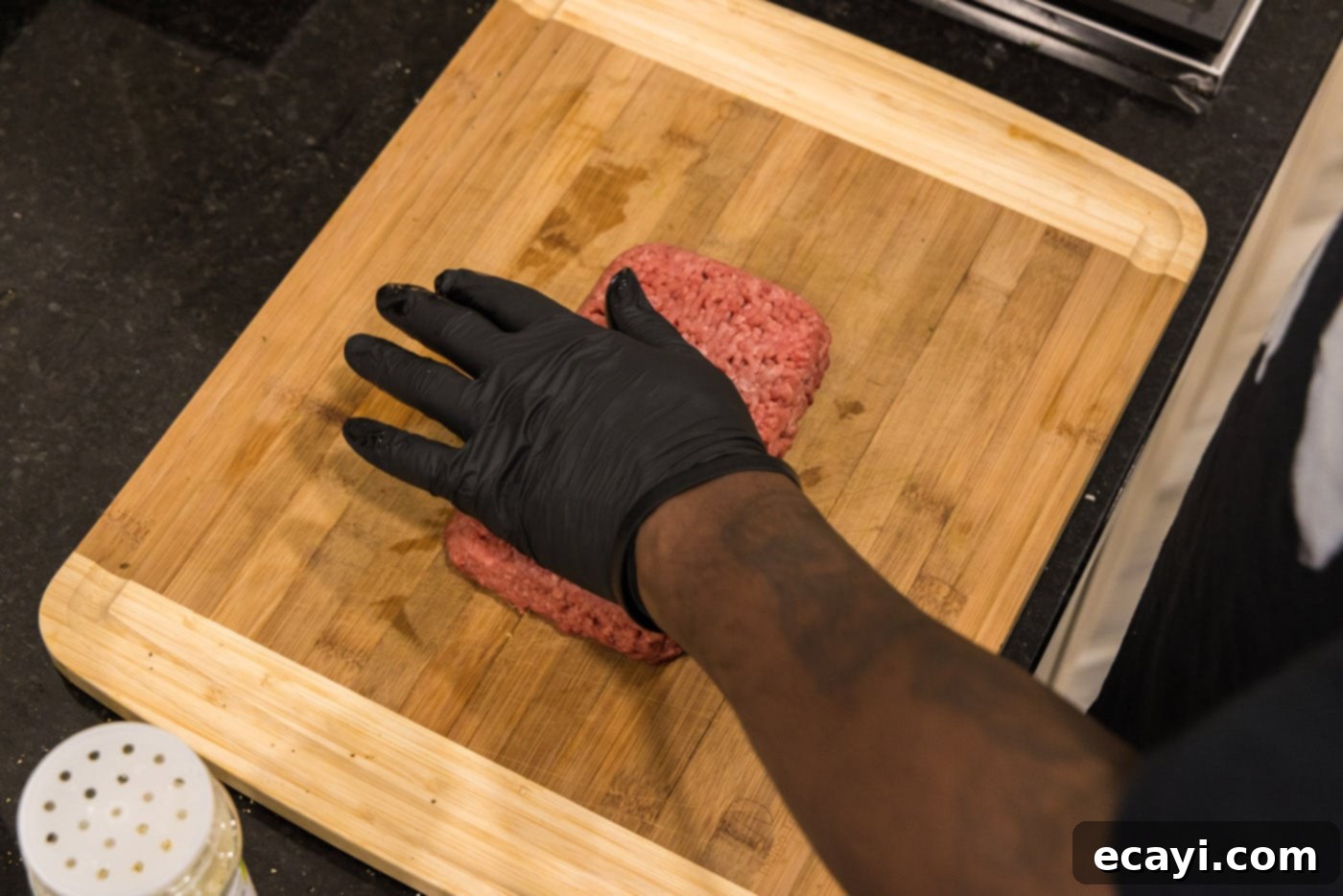 The Smash Burger 5 hand pressing down on ground beef