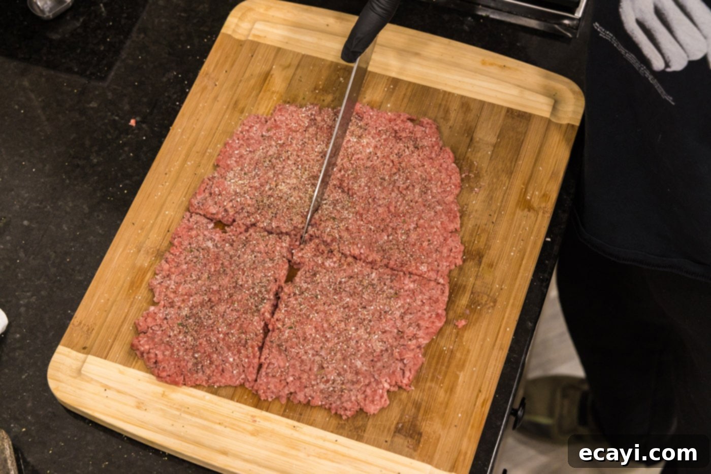 The Smash Burger 7 slicing ground beef into 4 sections