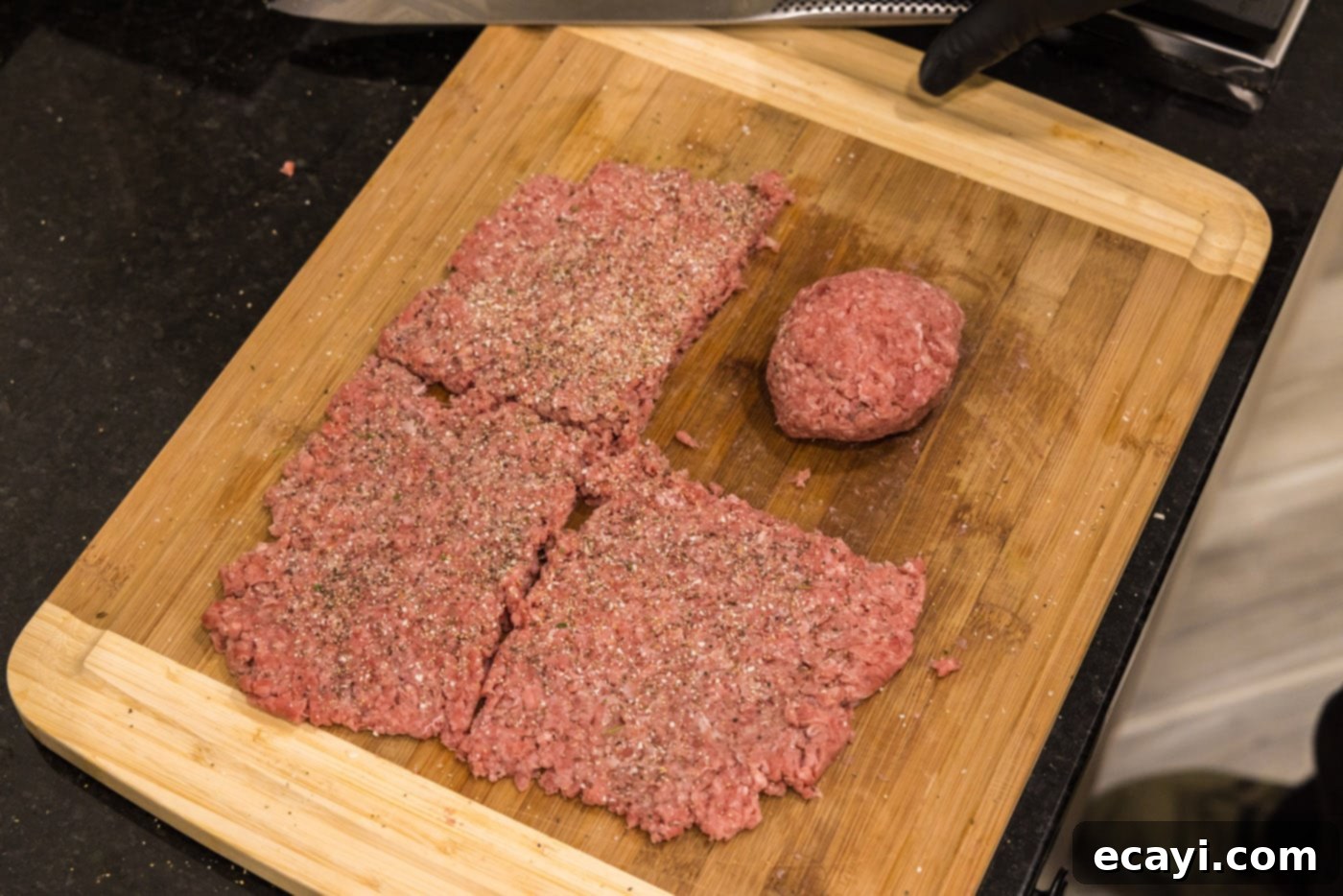The Smash Burger 8 rolling burger meat on a cutting board