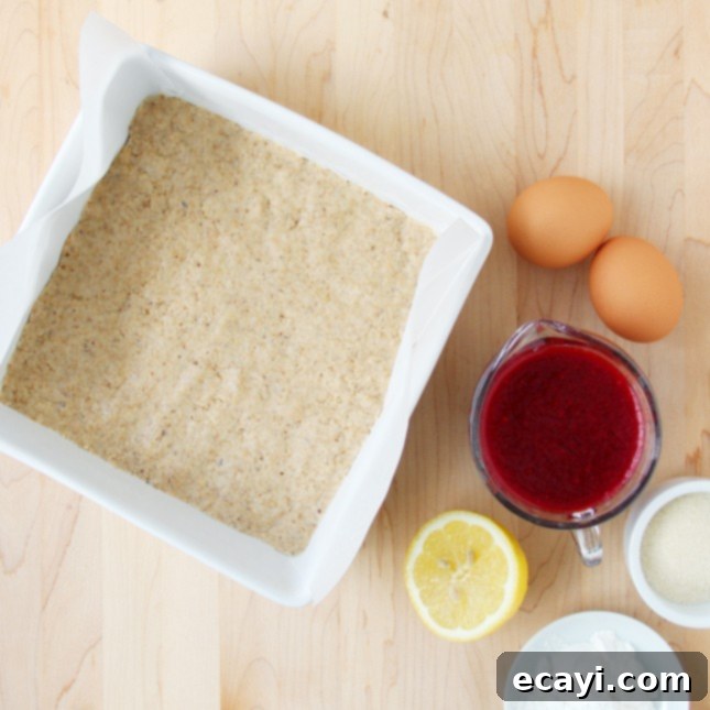The Ultimate Guide to Fruit Squares: Any Fruit, Any Season 6 Pressing the fruit square crust into a baking pan.