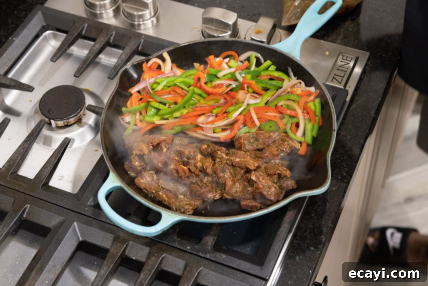 Sizzling Steak Fajitas 11 marinated beef strips added to pan with veggies for fajitas