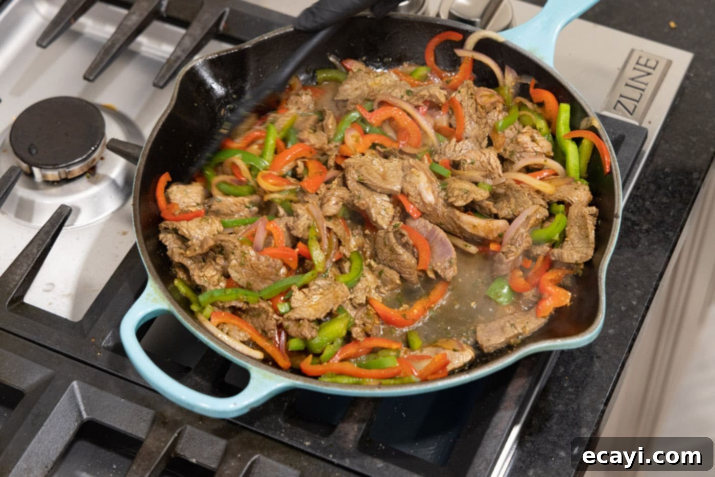 Sizzling Steak Fajitas 12 steak fajita filling in a cast iron skillet