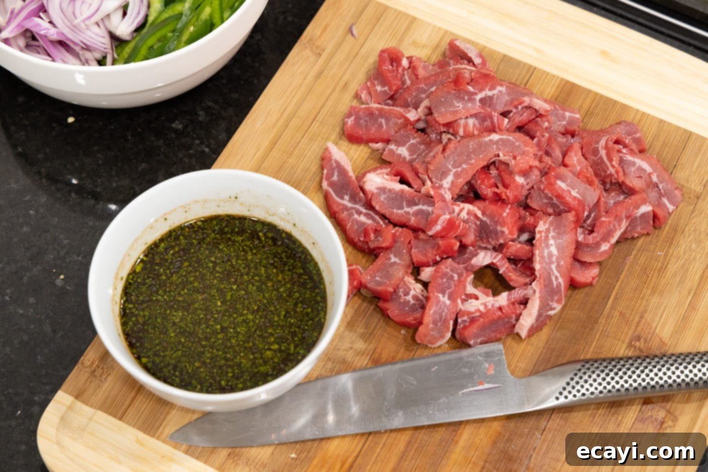 Sizzling Steak Fajitas 5 sliced flank steak with marinade on the side
