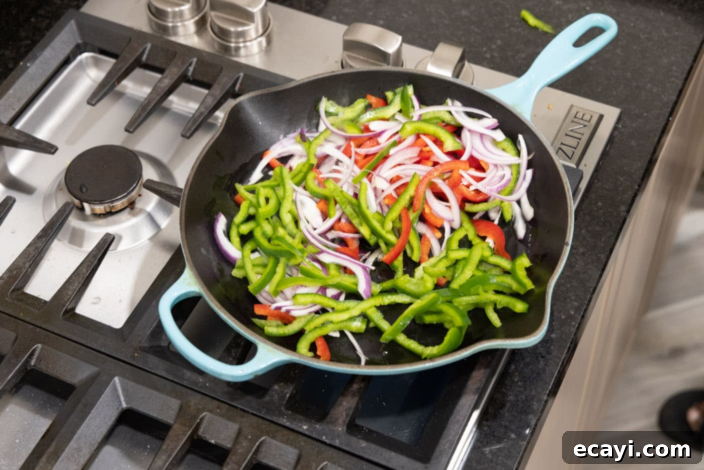 Sizzling Steak Fajitas 9 cooking bell peppers and onions in a skillet with oil
