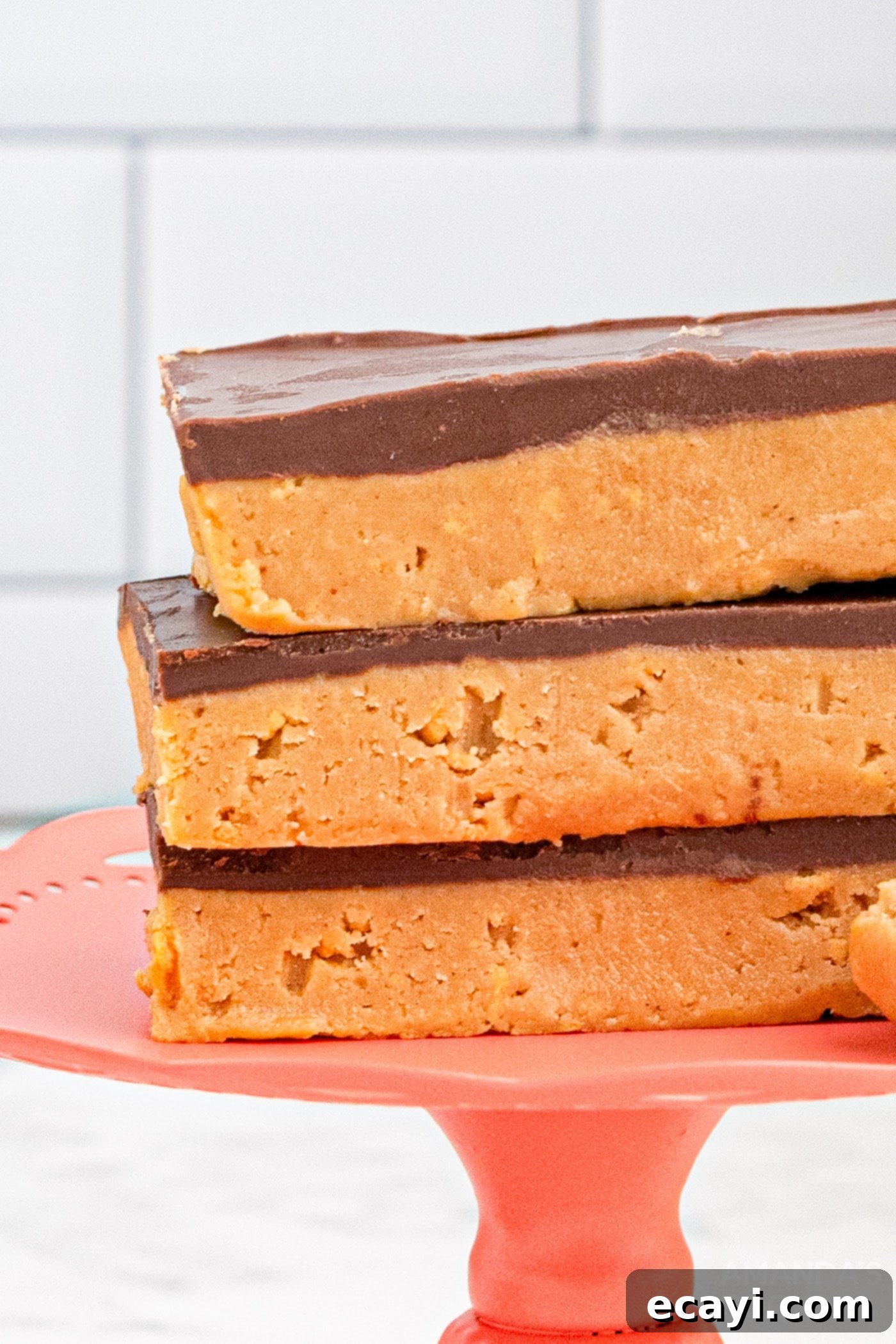 Peanut Butter Dream Bars 3 stack of no-bake chocolate peanut butter bars on a white plate