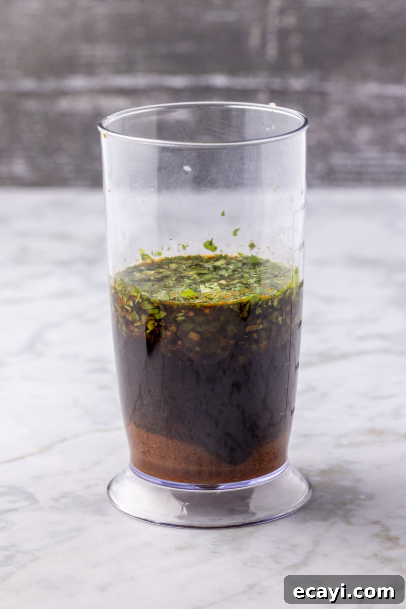 Ultimate Fajita Marinade 5 Fajita marinade ingredients are placed in an immersion blender cup, ready for blending.