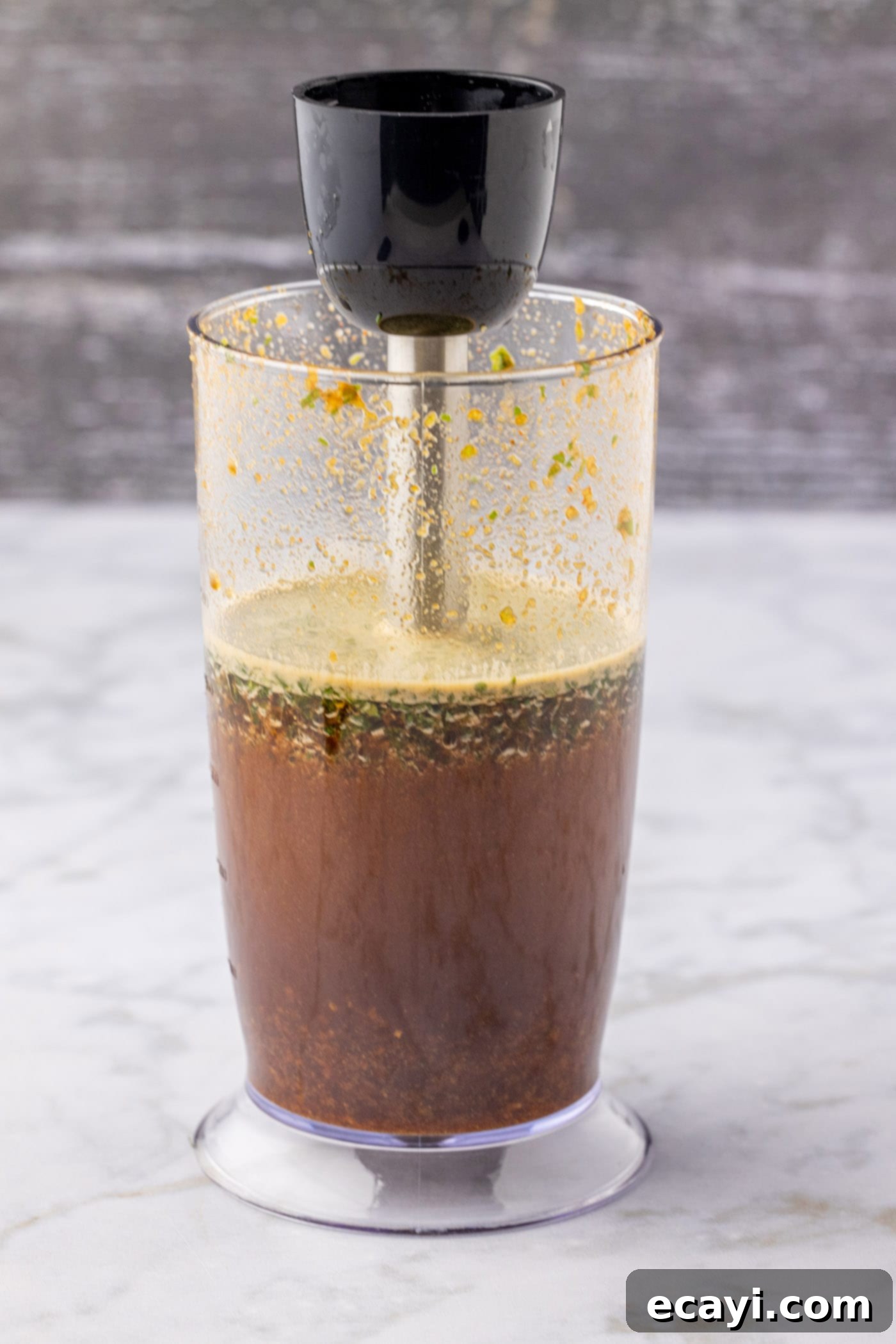 Ultimate Fajita Marinade 6 The immersion blender is actively blitzing the marinade ingredients, creating a smooth mixture.