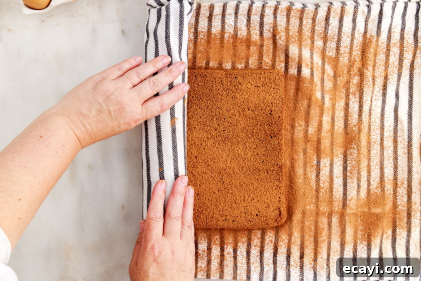 Velvet Chocolate Swirl 16 rolling swiss roll cake with a tea towel
