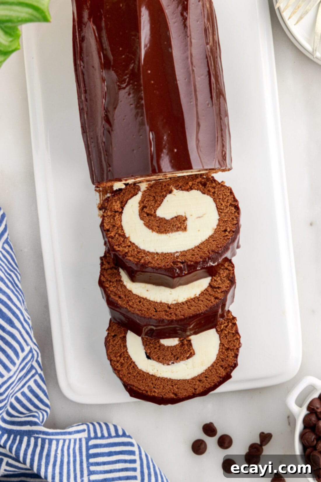 Velvet Chocolate Swirl 28 Swiss Roll and three slices on a white platter