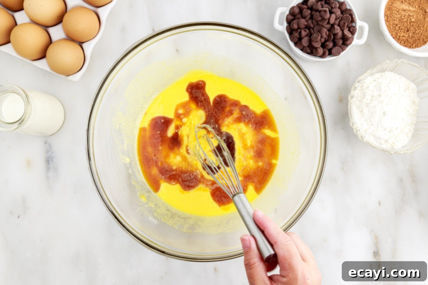 Velvet Chocolate Swirl 7 whisking vanilla, egg yolks, and oil in a bowl