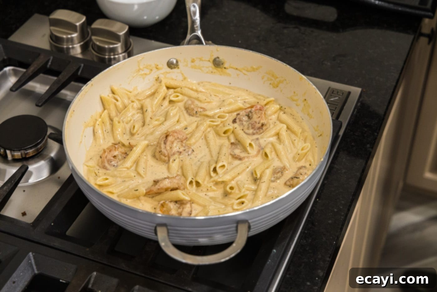 Creamy Cajun Shrimp Pasta 15 The final creamy Cajun shrimp pasta dish simmering on the stovetop, rich and ready to be served.