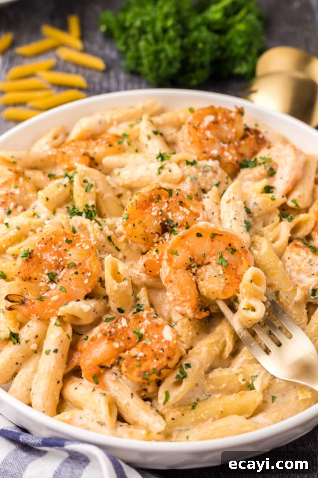 Creamy Cajun Shrimp Pasta 16 An inviting close-up of a serving of Cajun shrimp pasta on a fork, showcasing the rich sauce, tender shrimp, and perfectly cooked noodles.