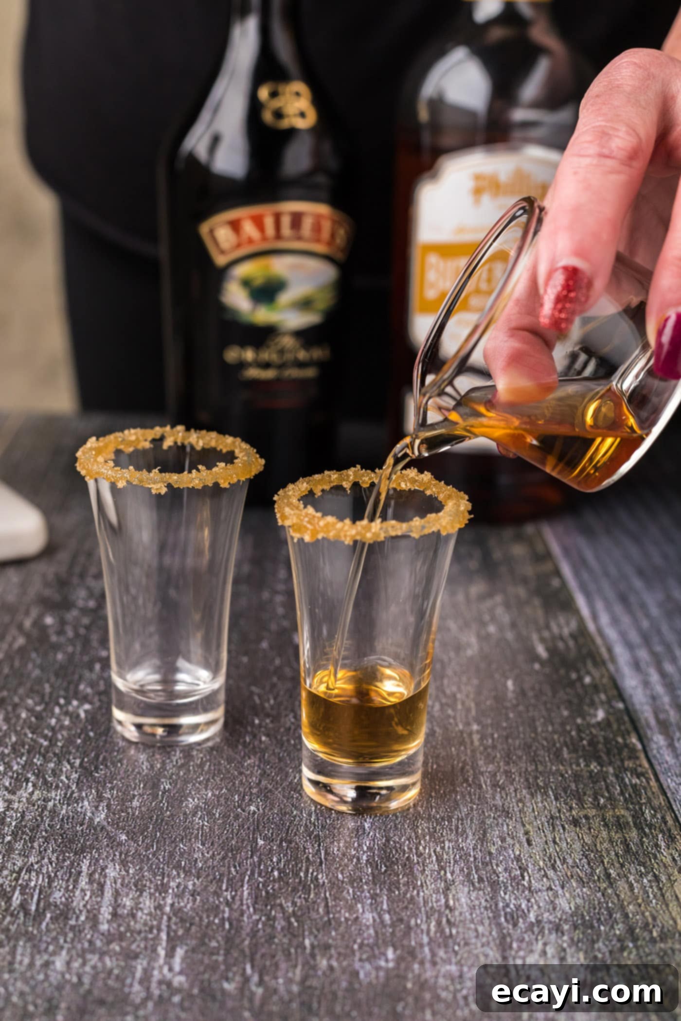 Buttery Nipple Bliss 7 Pouring butterscotch schnapps into a shot glass