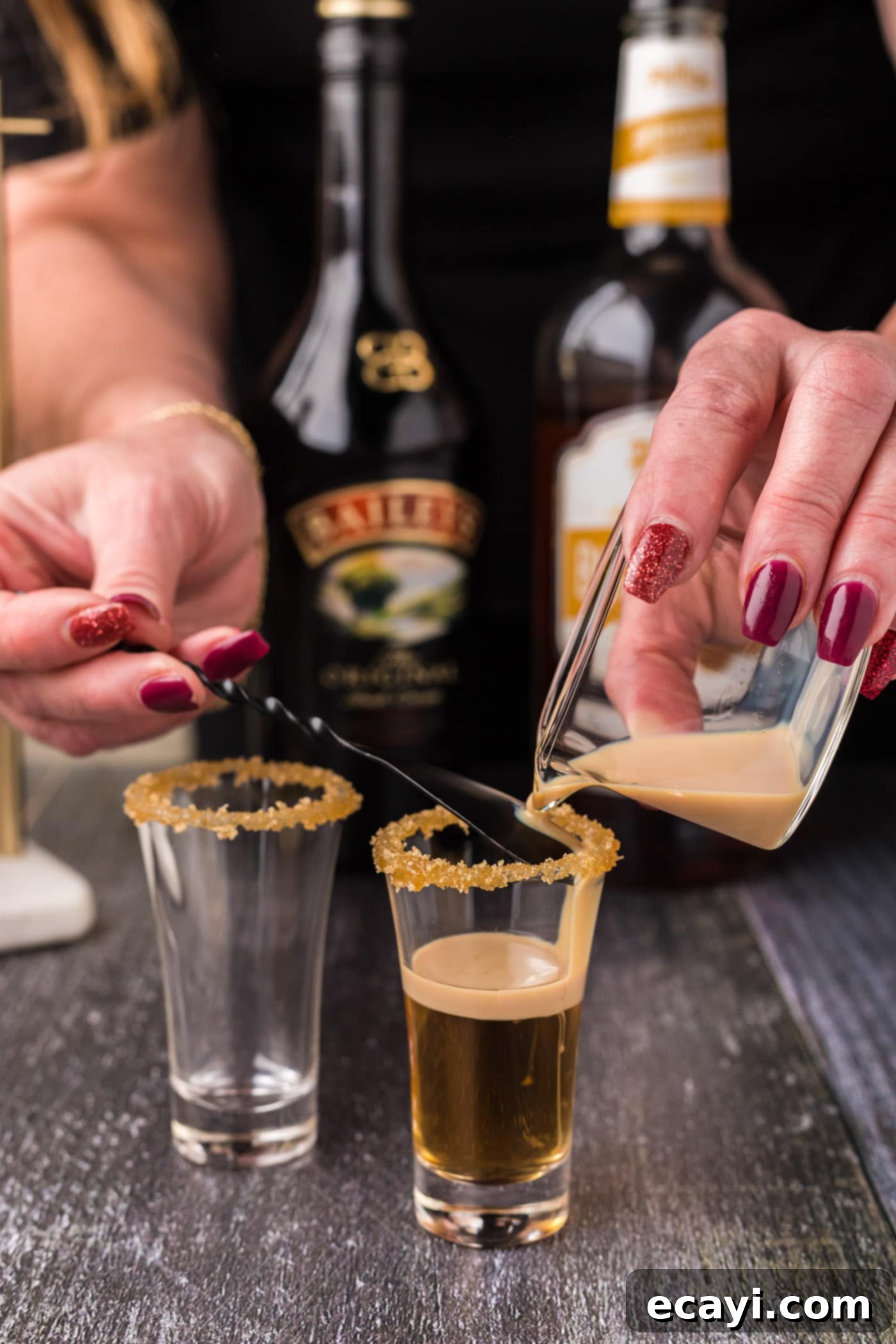Buttery Nipple Bliss 8 Gently pouring Irish cream over butterscotch schnapps using the back of a spoon to create layers