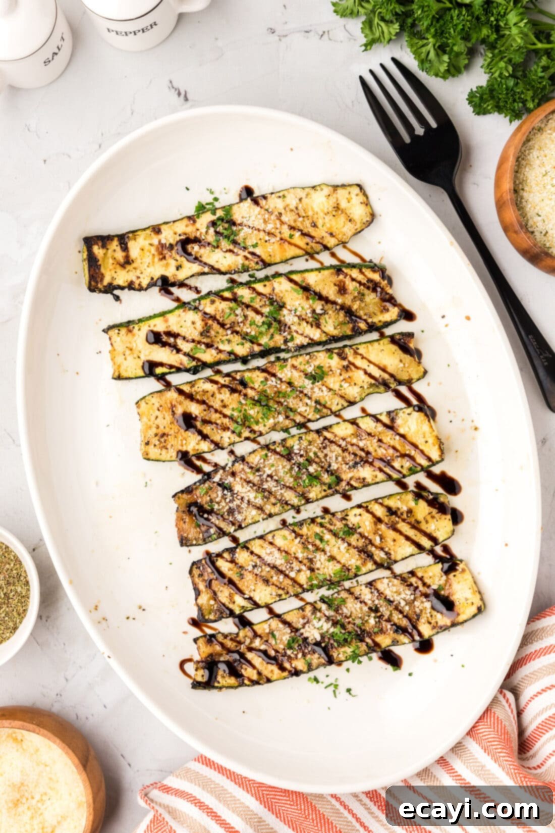 Smoky Zucchini Perfection 3 A vibrant platter of grilled zucchini, elegantly topped with a glistening balsamic glaze, ready for serving.