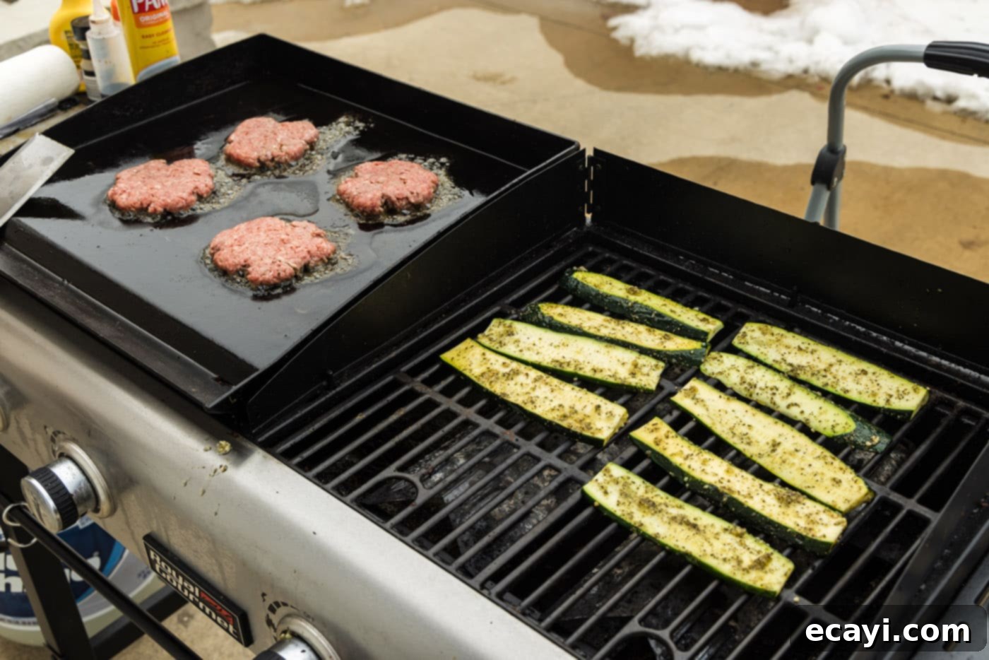 Smoky Zucchini Perfection 8 Zucchini slices grilling alongside burger patties on a combo grill, illustrating simultaneous cooking.