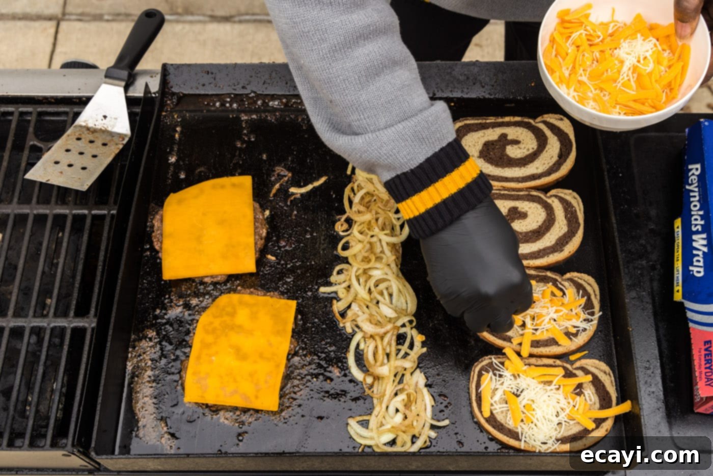 Patty Melt 14 adding cheese to rye bread on a grill with onions and burgers
