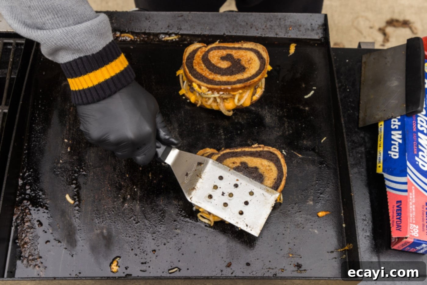 Patty Melt 18 spatula pressing down on patty melt on a griddle