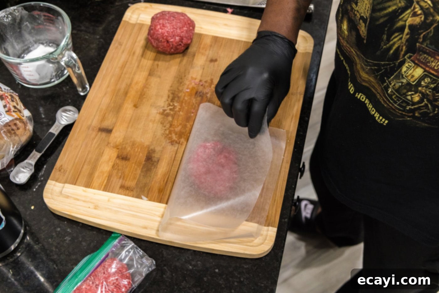 Patty Melt 5 placing parchment paper over burger meat