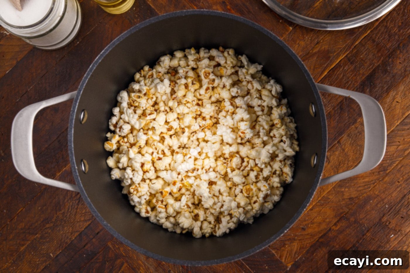 Irresistible Sweet & Salty Crunch 10 Kettle corn popping vigorously in a lidded pot on the stovetop