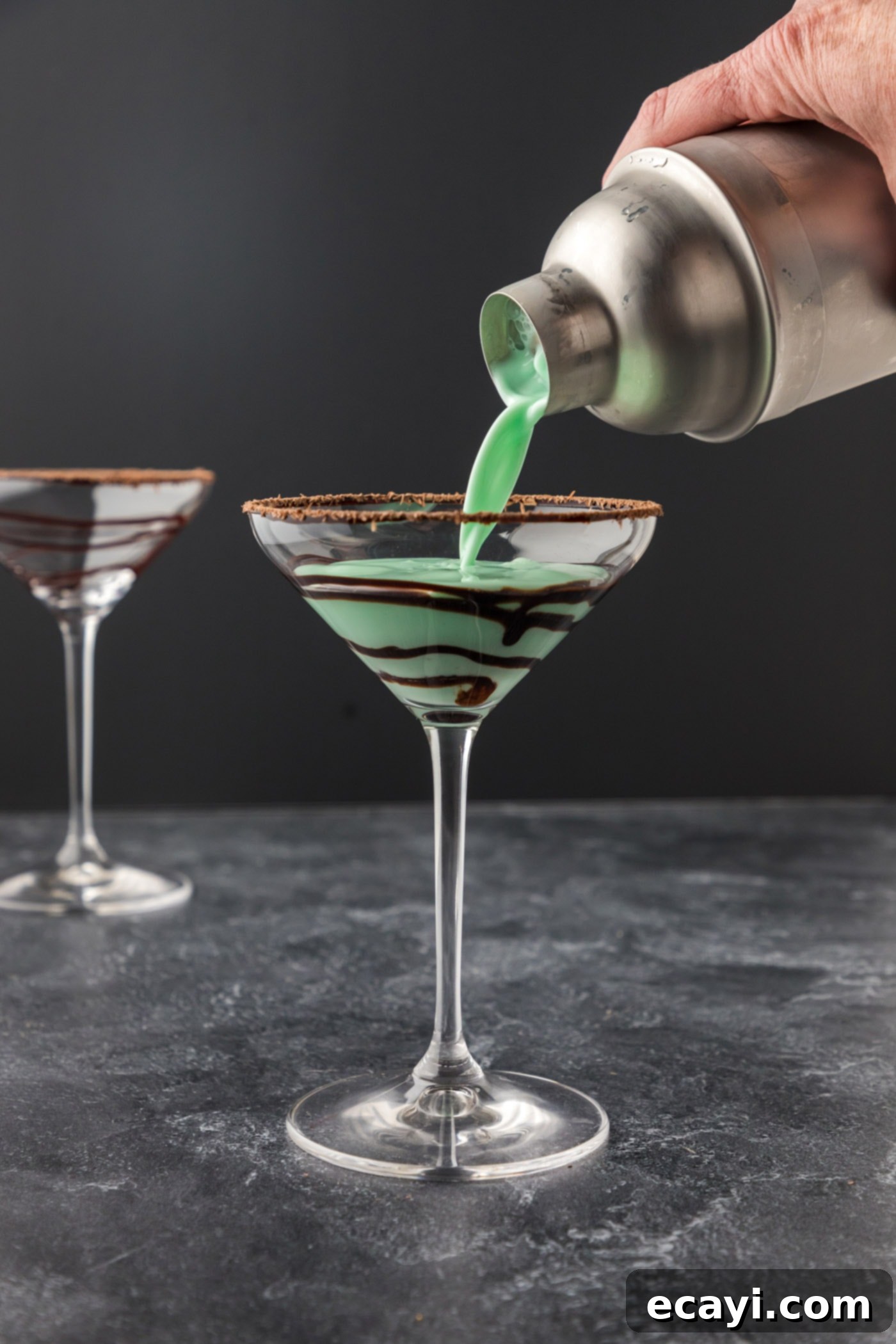 Velvet Grasshopper 11 pouring the mixed grasshopper cocktail into a martini glass