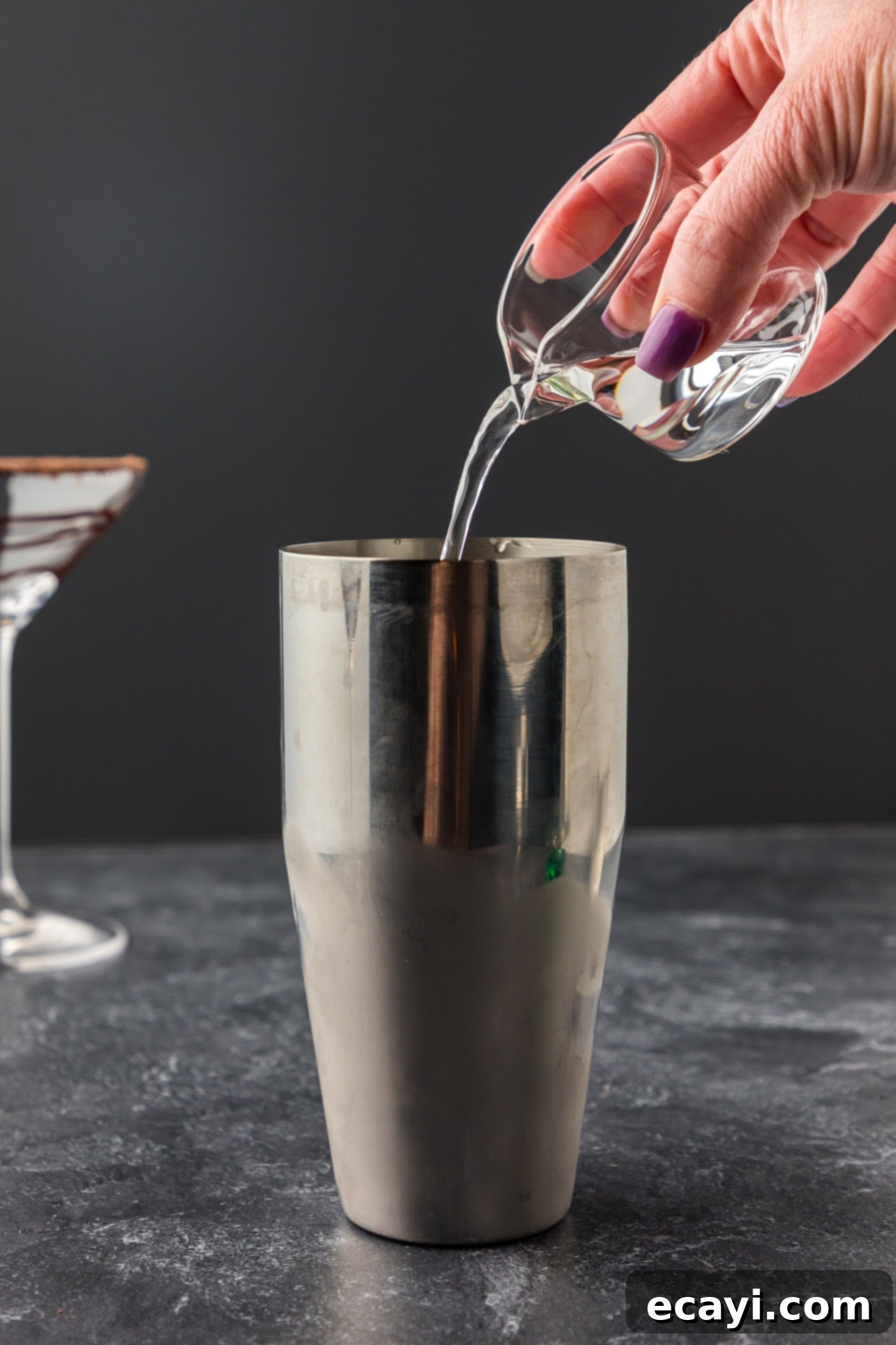 Velvet Grasshopper 8 adding creme de cacao to cocktail shaker with ice