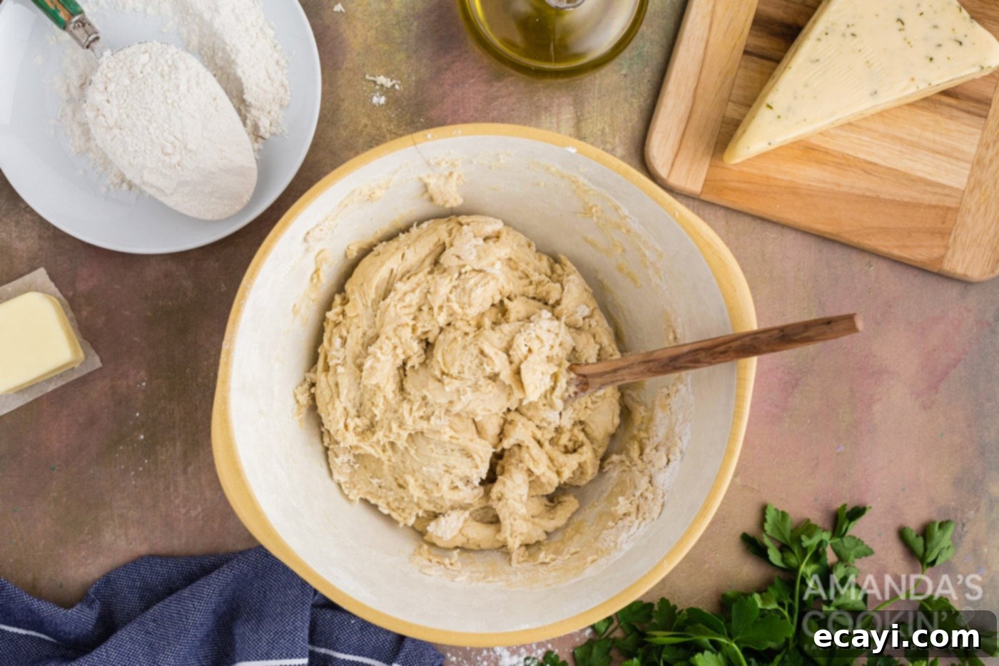 Golden Cheesy Garlic Buns 7 dough in a bowl with wooden spoon