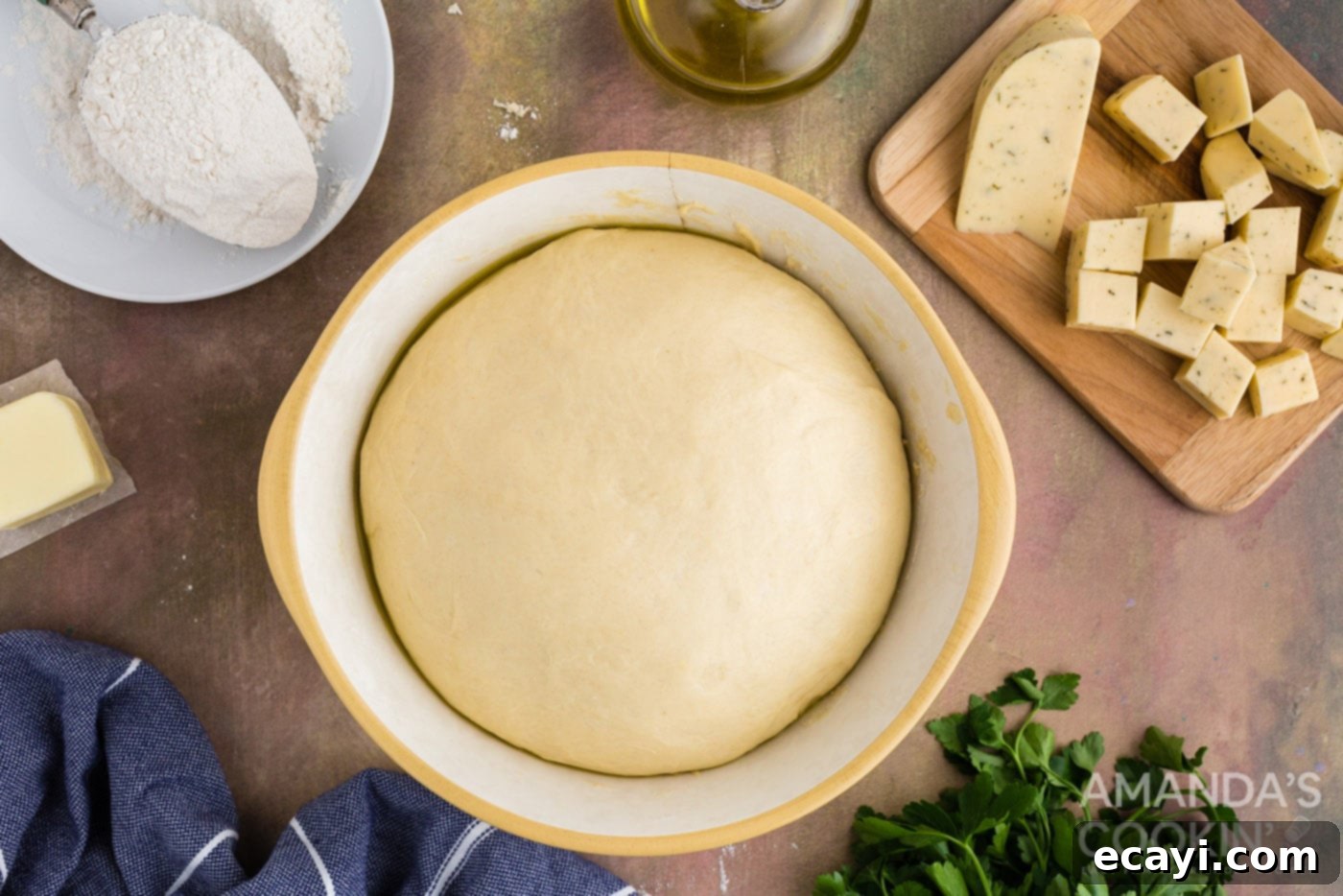 Golden Cheesy Garlic Buns 9 risen dough ball in a bowl