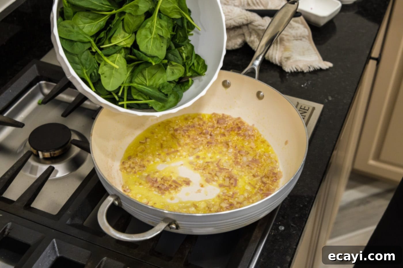 Gourmet Stuffed Salmon 6 adding spinach to pan with shallots and garlic