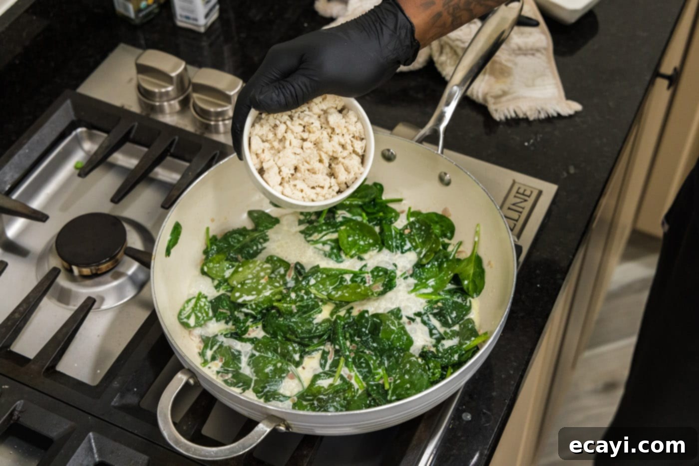 Gourmet Stuffed Salmon 8 adding crab meat to skillet with spinach