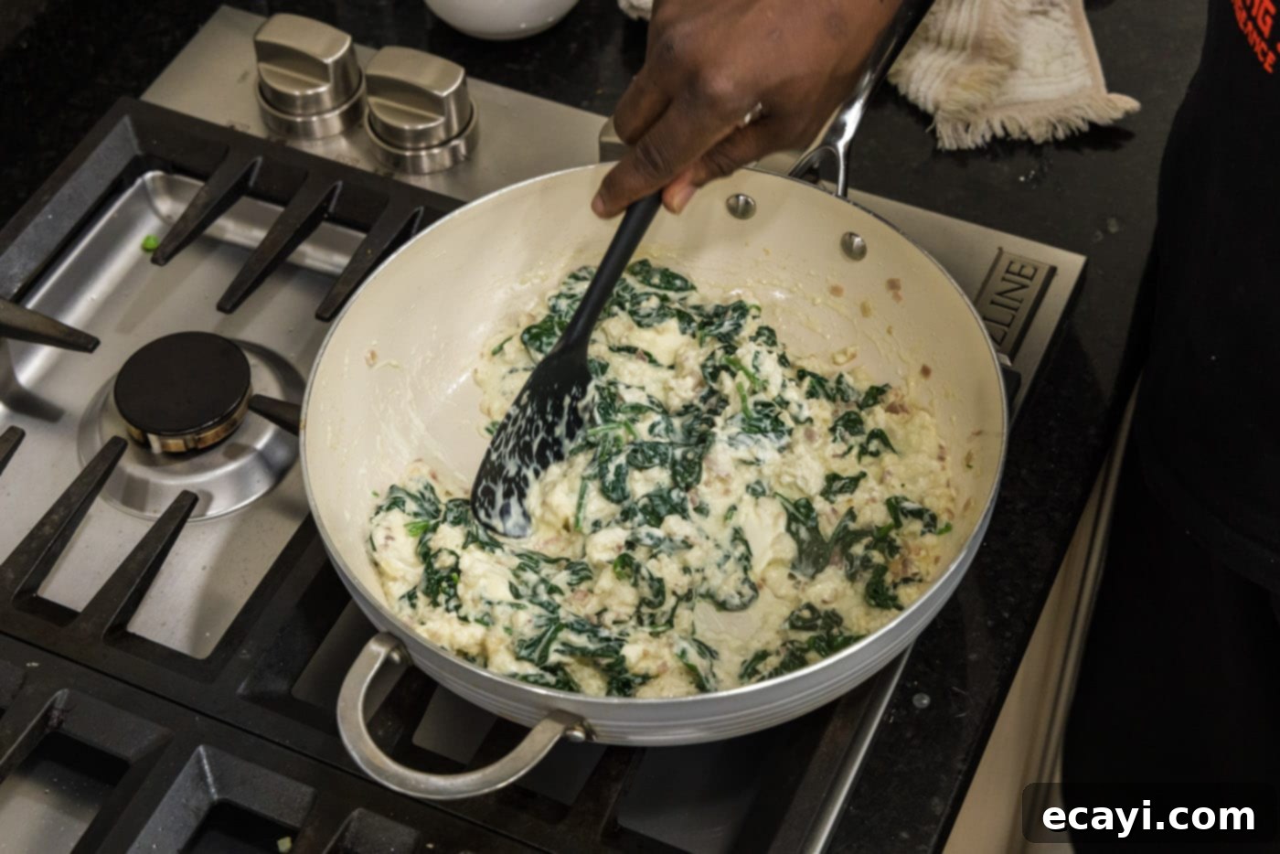 Gourmet Stuffed Salmon 10 stirring cream cheese spinach mixture in a skillet