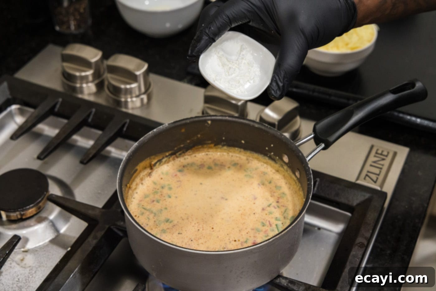 Creamy Queso 11 Preparing cornstarch slurry in a bowl to thicken queso dip