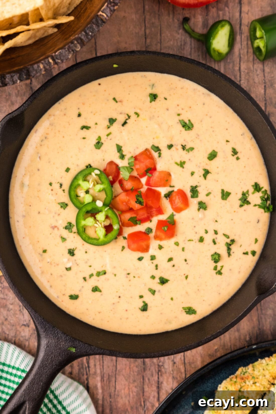 Creamy Queso 13 Overhead photo of a skillet of delicious homemade White Queso Dip garnished with diced peppers