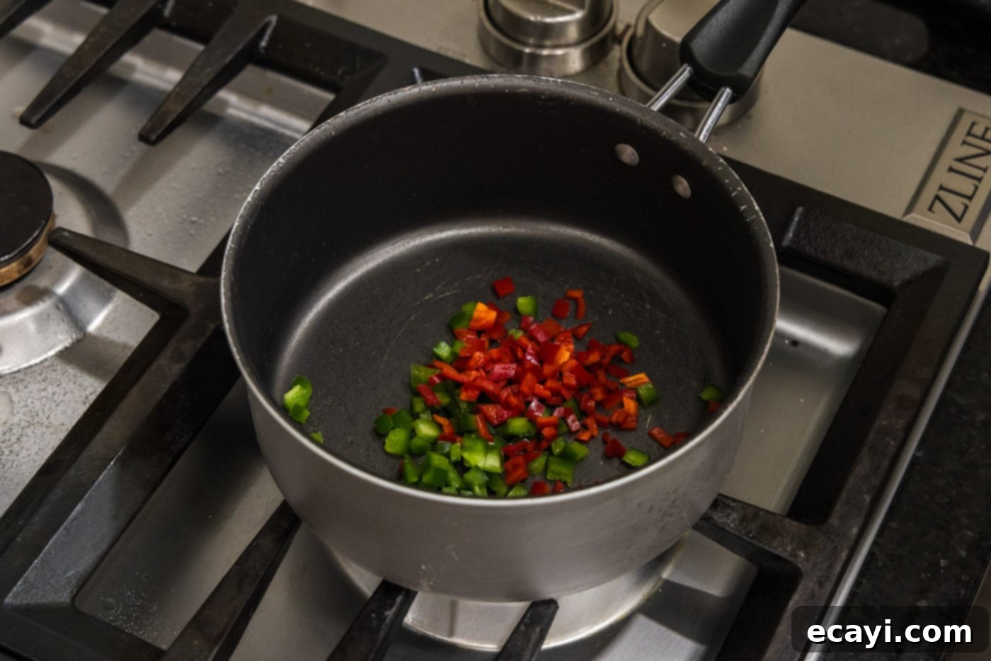 Creamy Queso 5 Chopped red chiles and jalapenos in a saucepan, ready for queso dip