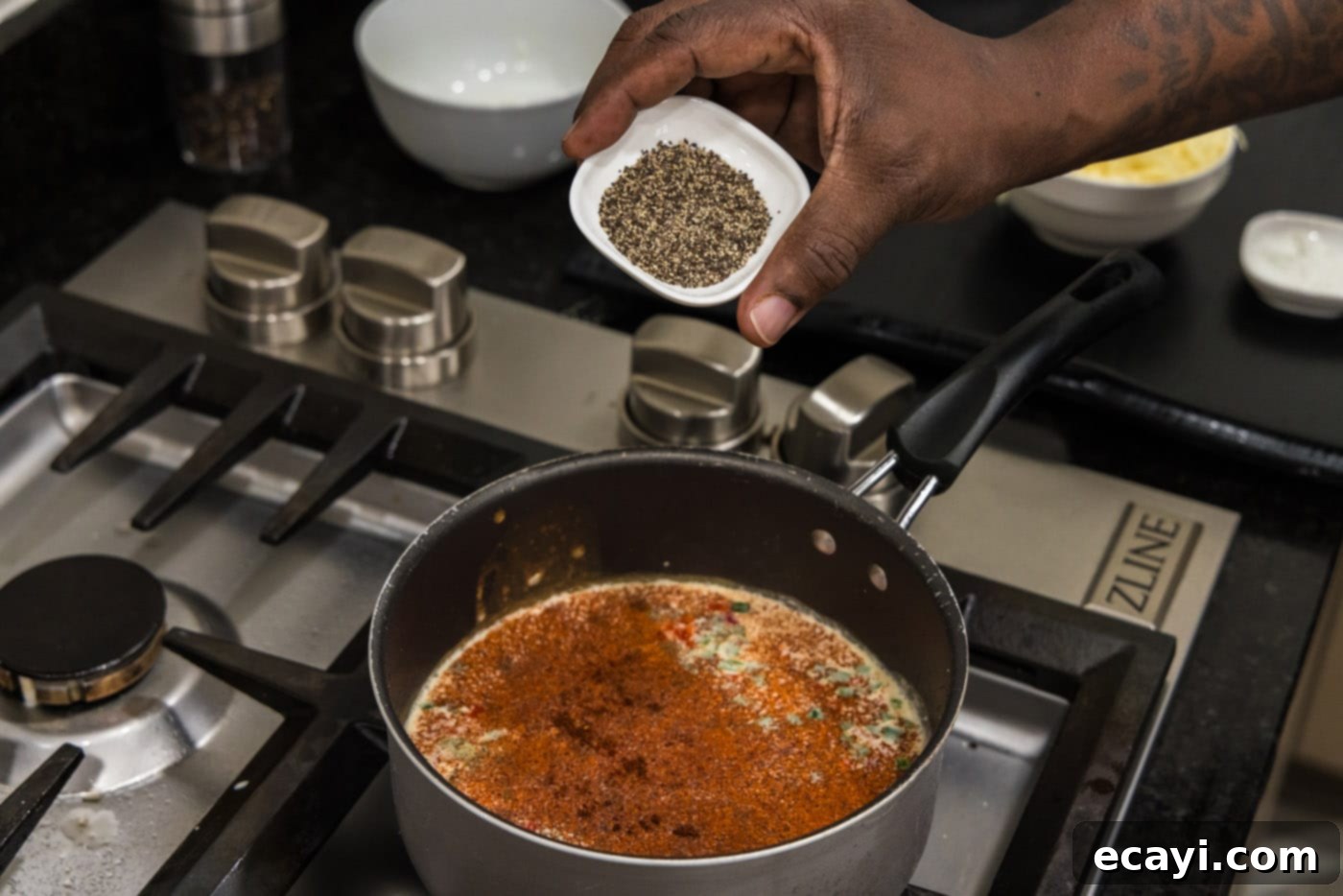 Creamy Queso 7 Adding chili powder and black pepper to the evaporated milk and pepper mixture