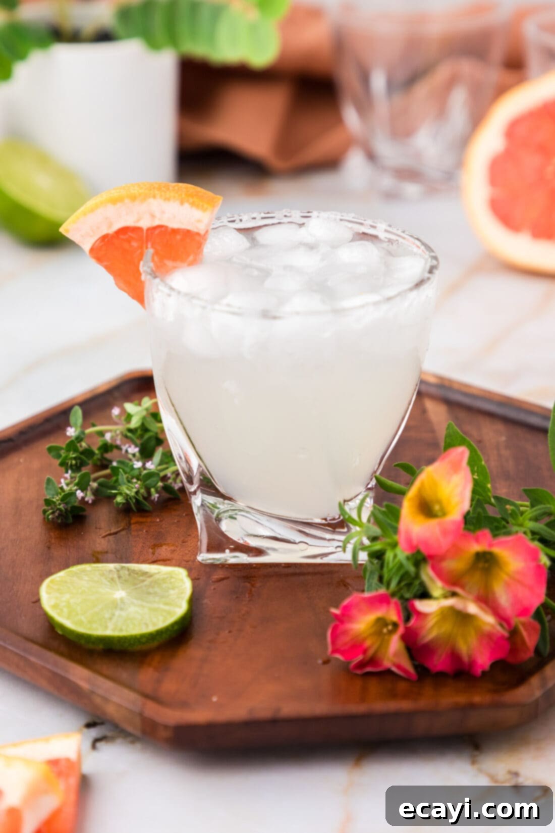 Paloma 13 Paloma on a wooden tray with flowers and a lime wheel