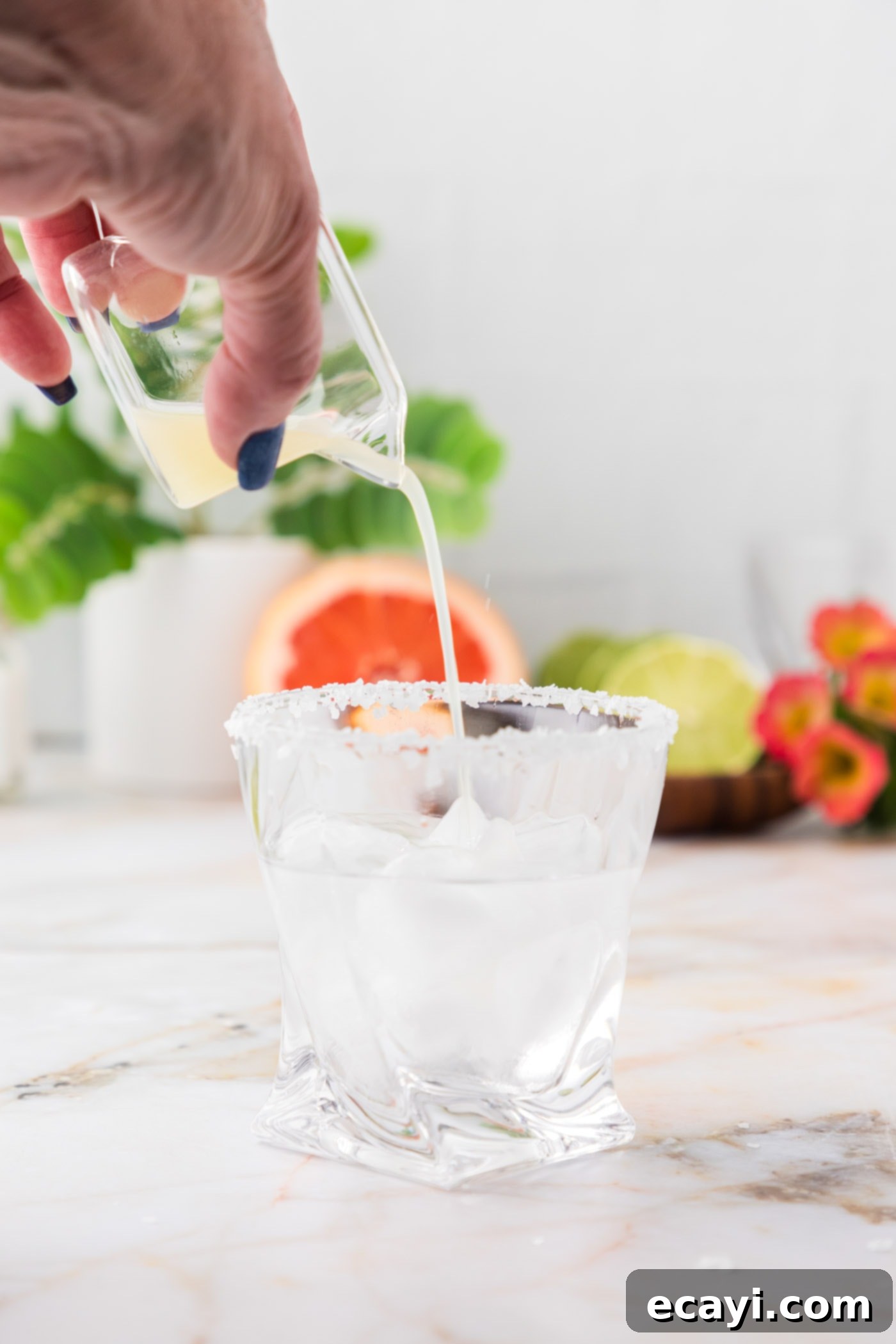 Paloma 9 pouring lime juice over blanco tequila