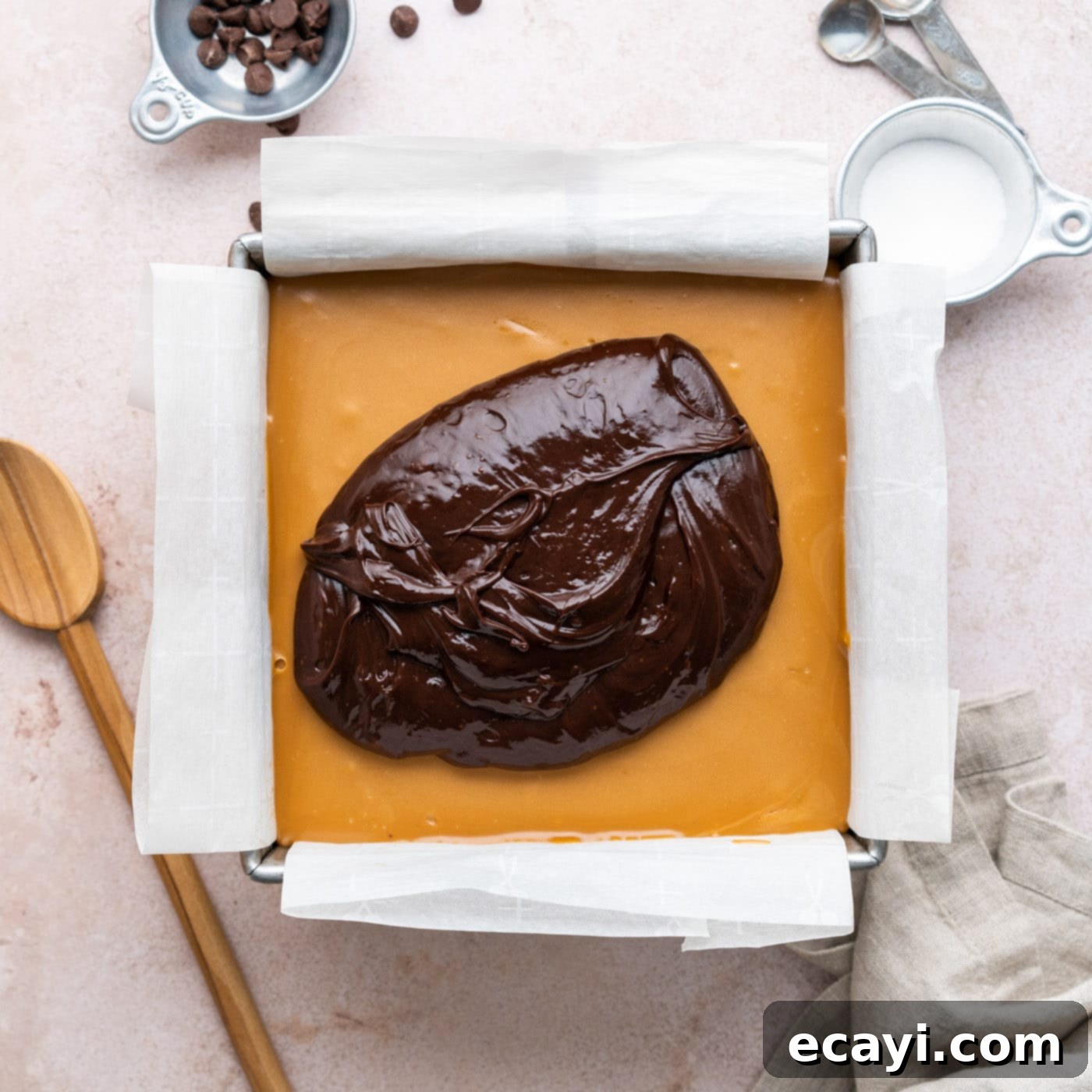 Decadent Millionaire Brownies 19 Spreading a layer of silky chocolate ganache over the set caramel and brownie layers.