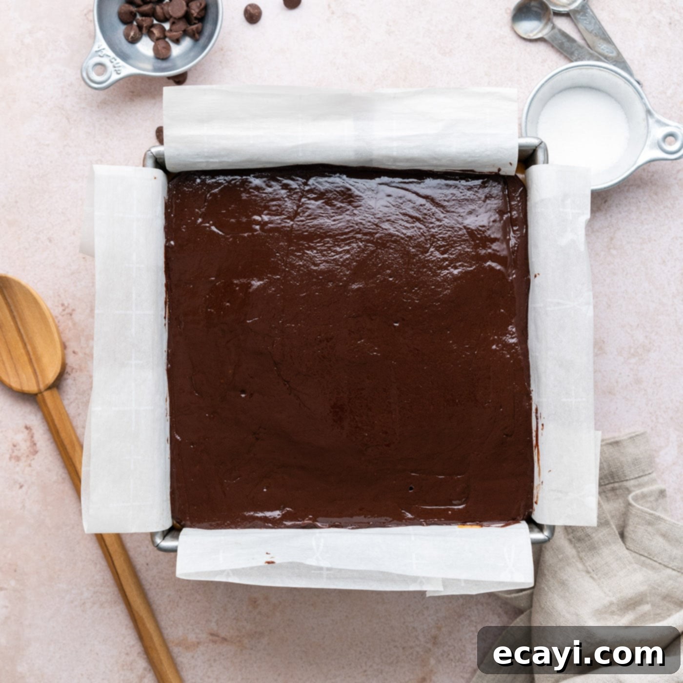 Decadent Millionaire Brownies 20 Overhead view of the chocolate ganache layer covering the caramel and brownies in the pan.