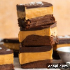 Decadent Millionaire Brownies 22 Stack of Millionaire Brownies showcasing the distinct layers of brownie, caramel, and ganache.