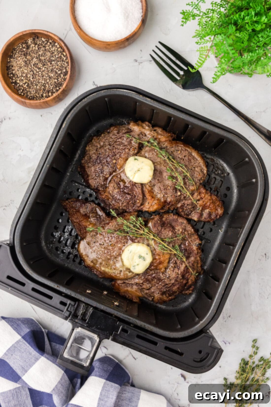 Restaurant-Quality Air Fryer Steak 2 Two cooked steaks in an Air Fryer, perfectly seared and ready to eat.