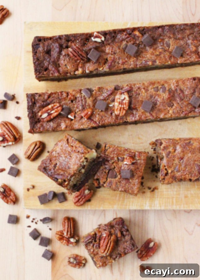 Rich Chocolate Pecan Bars 3 Close-up of a square chocolate pecan pie bar, showcasing the rich filling and crunchy pecans