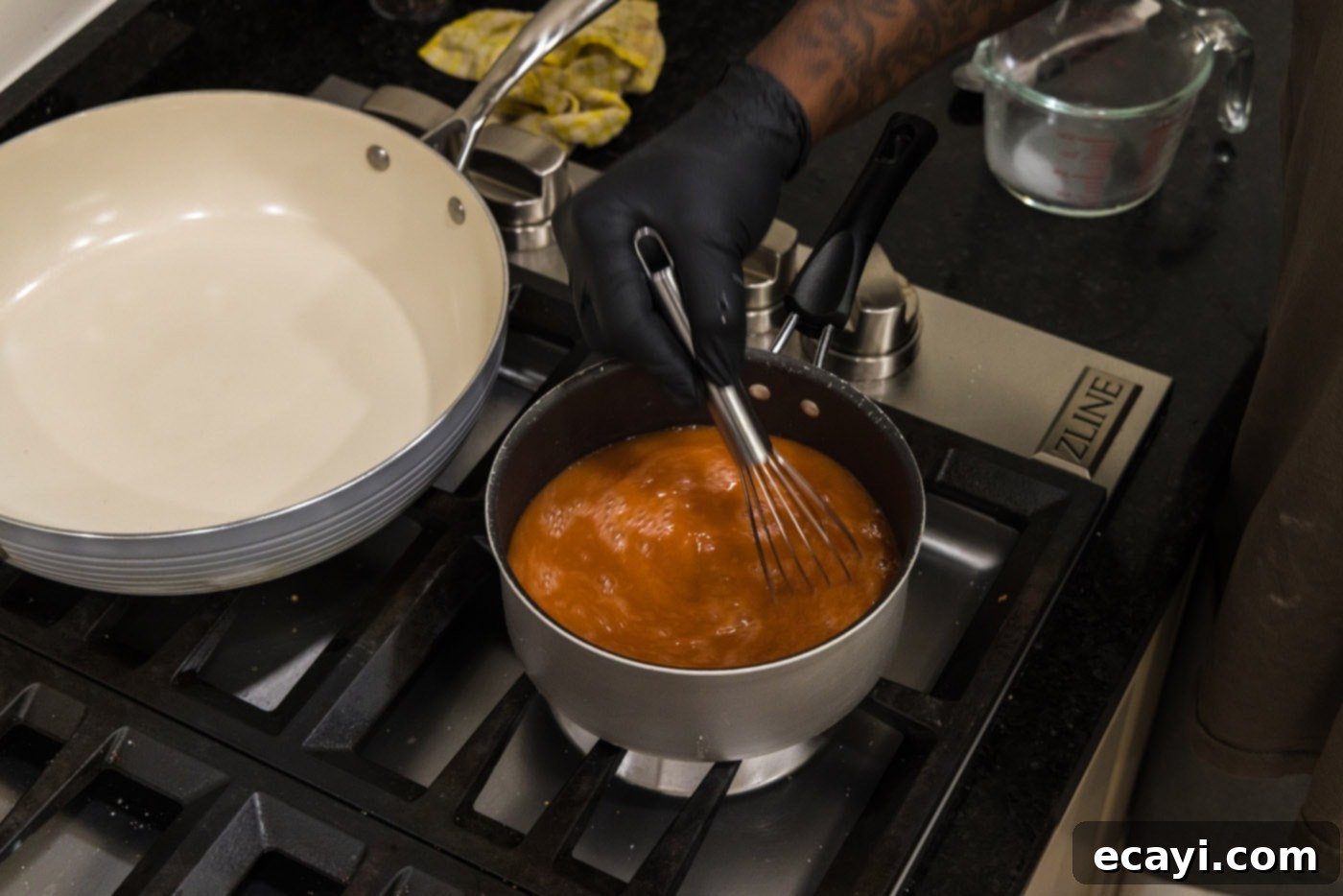 Zesty Sweet Fusion 7 whisking sauce in a pot over heat