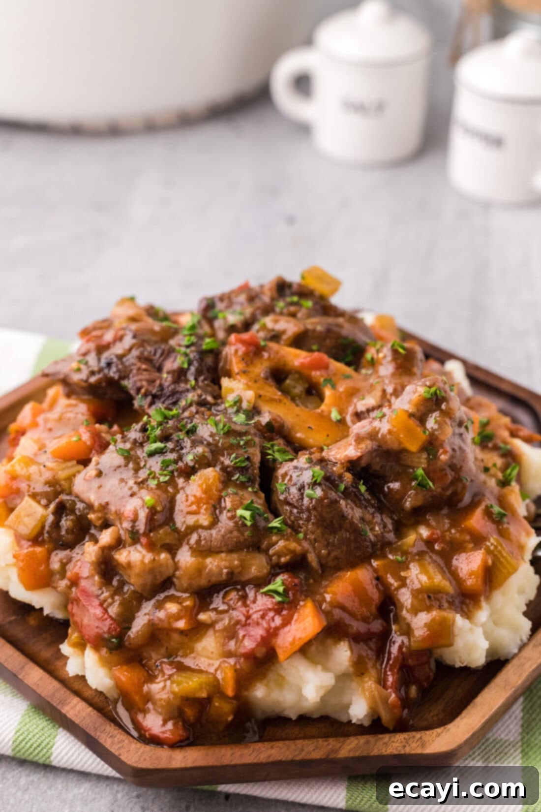 Melt-in-Your-Mouth Braised Beef Shanks 2 Plate of perfectly braised beef shanks garnished with fresh herbs, showcasing the rich sauce and tender meat